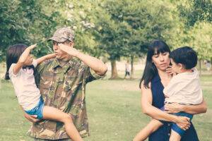 military dad, wife and children in park