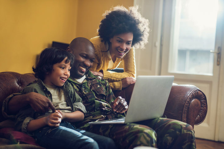 military family looking at laptop