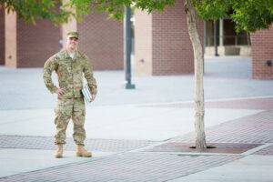 military reservist on campus holding books