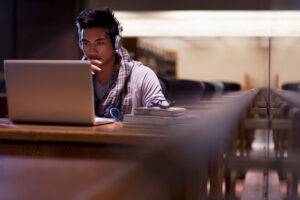 student studying cybersecurity on laptop