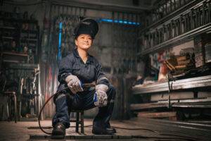 female welder in helmet