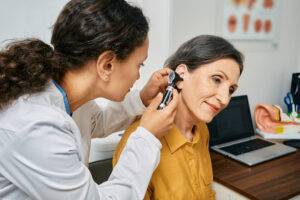 allied health female checking ears