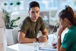 army soldier sitting with social worker