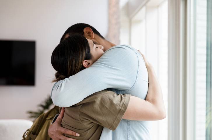 female soldier hugs her spouse