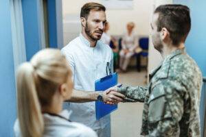 military shaking doctor's hand