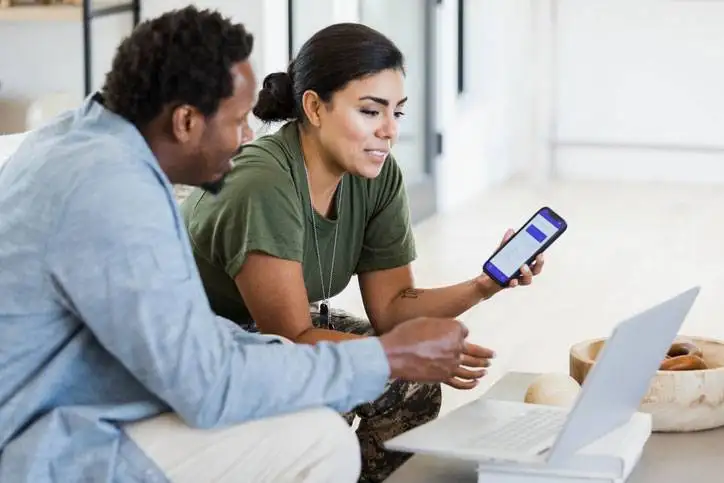 military spouse and soldier on laptop