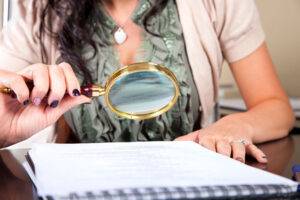 paralegal woman with magnifying glass