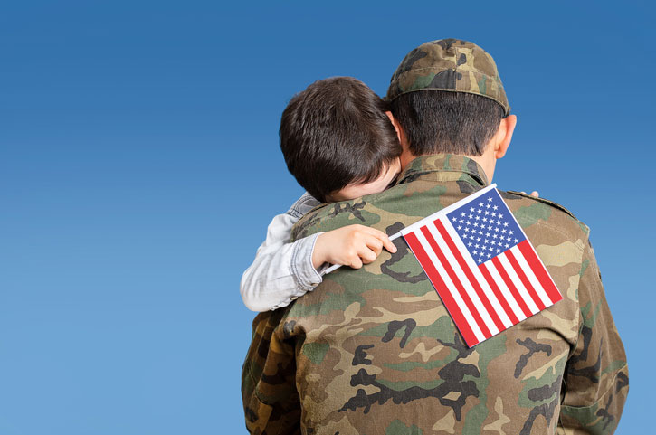 son hugging soldier dad