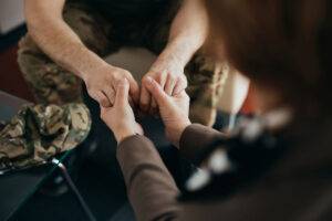 therapist holding hands of soldier