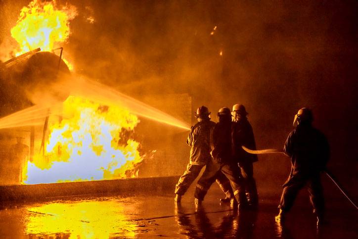 firefighters extinguishing an industrial fire