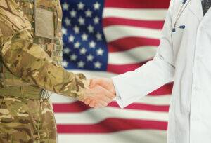 health professional and soldier shaking hands