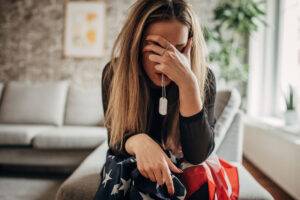 widow sitting with flag and tags