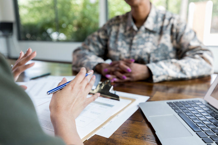 Female military officer talks with benefits advisor