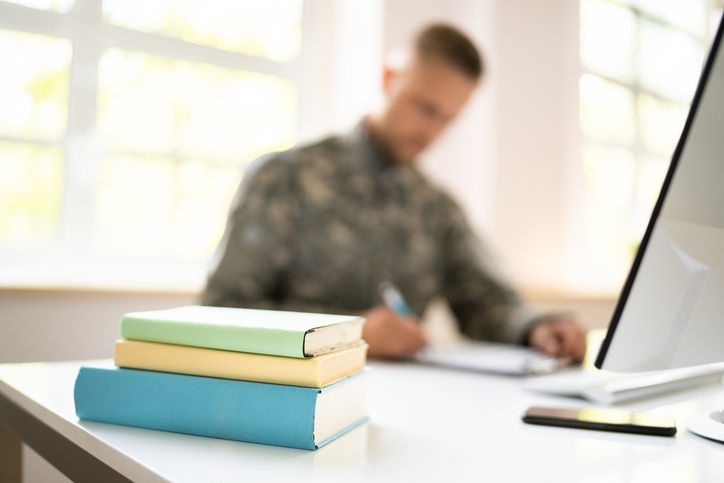 A student military member at a computer