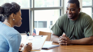 soldier interviewing with woman