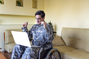 soldier in wheelchair on laptop